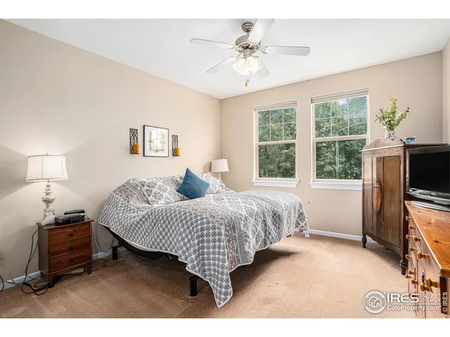 a bedroom with a bed and a tv