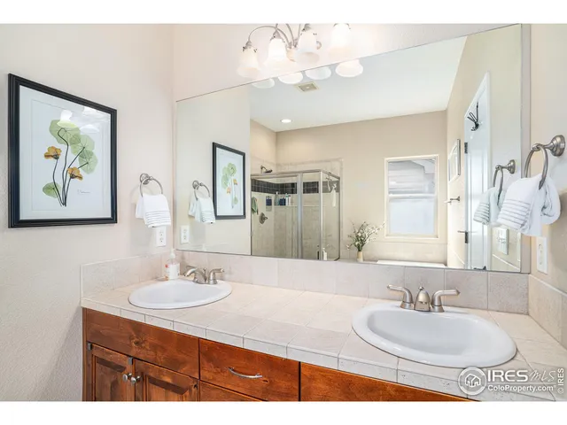 a bathroom with a sink double vanity granite and a mirror