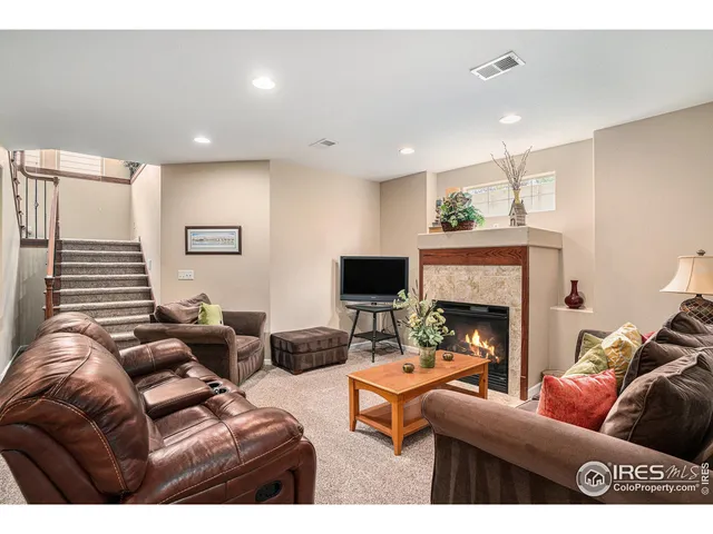 a living room with furniture fireplace and a flat screen tv