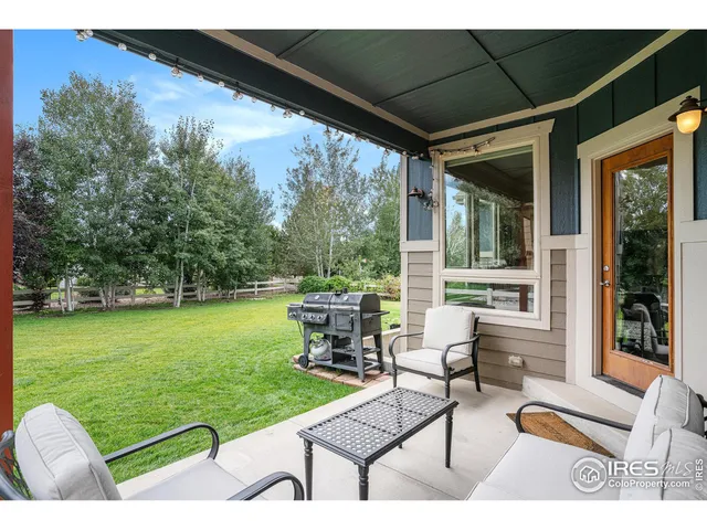 a view of a patio with table and chairs potted plants with sky view