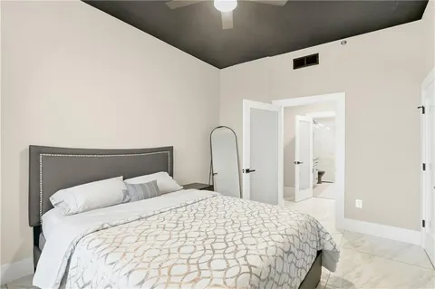 a bedroom with a bed and a large mirror