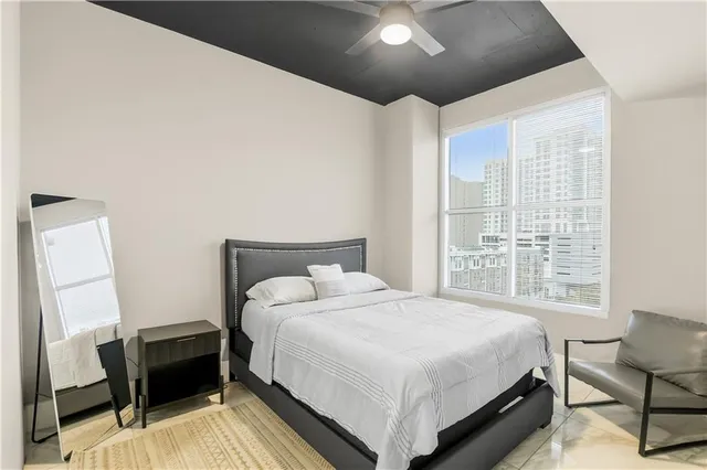 a bedroom with a bed and a chair