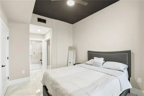 a bedroom with a bed and a lamp