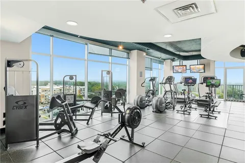 a room with gym equipment and large mirror