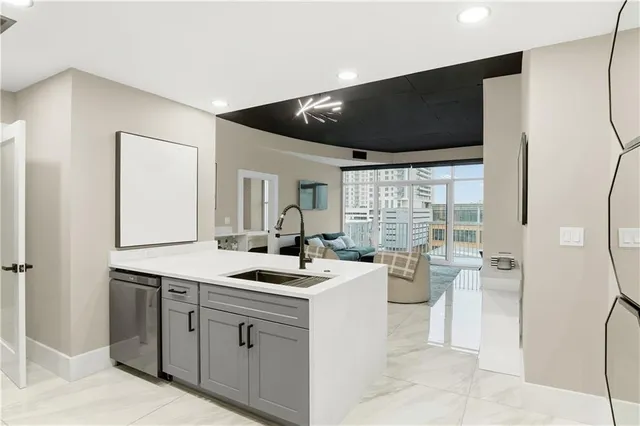a kitchen with a sink appliances and cabinets