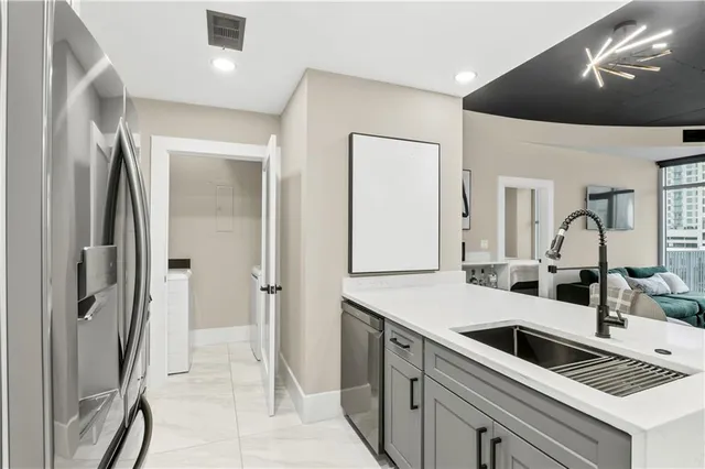 a kitchen with a sink and refrigerator