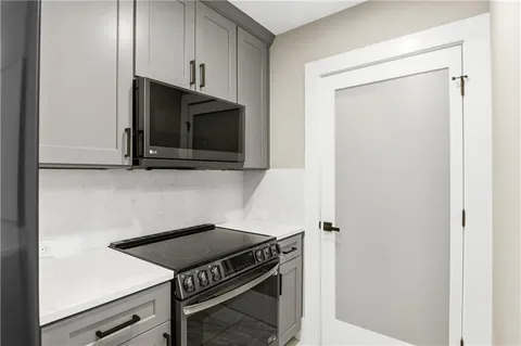 a kitchen with a stove and a microwave