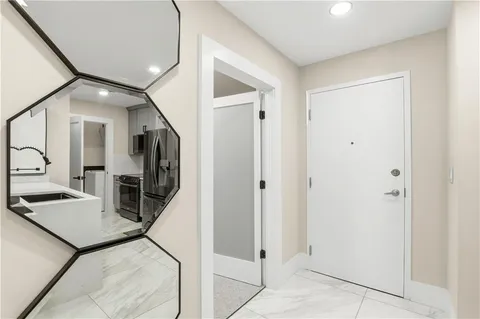 a view of a hallway with living room and furniture