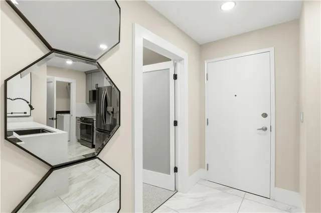 a view of a hallway with living room and furniture
