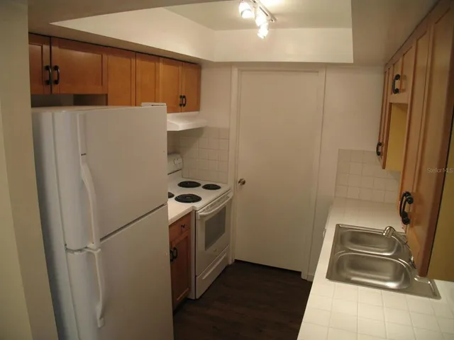 a utility room with wooden floor washer and dryer