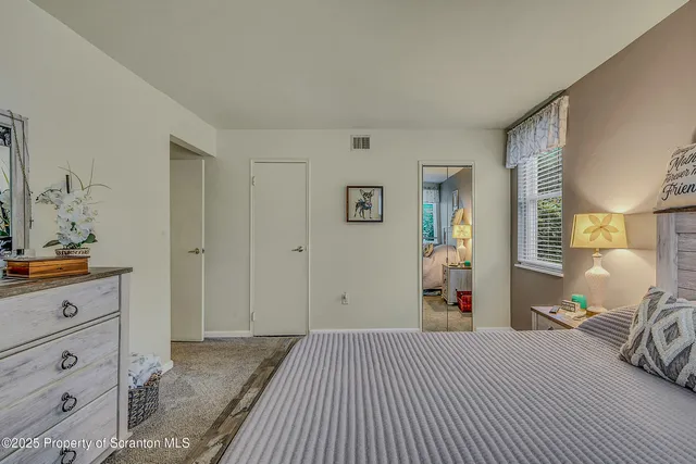 a bedroom with a large bed and dresser