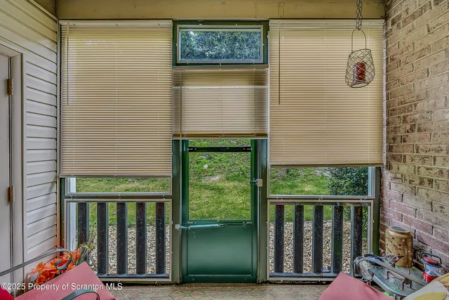 a balcony with a bench next to a yard