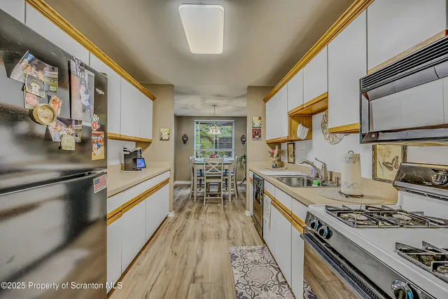 a kitchen with a stove a sink and a refrigerator