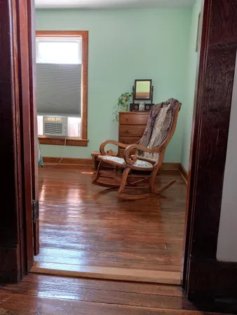 a room with wooden floor and furniture