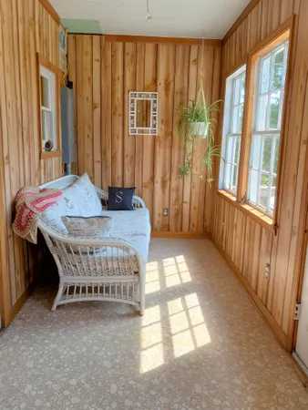 a bedroom with a bed table and a window