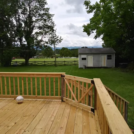 a view of a house with a yard and a garden