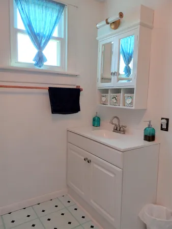 a bathroom with a sink and a window