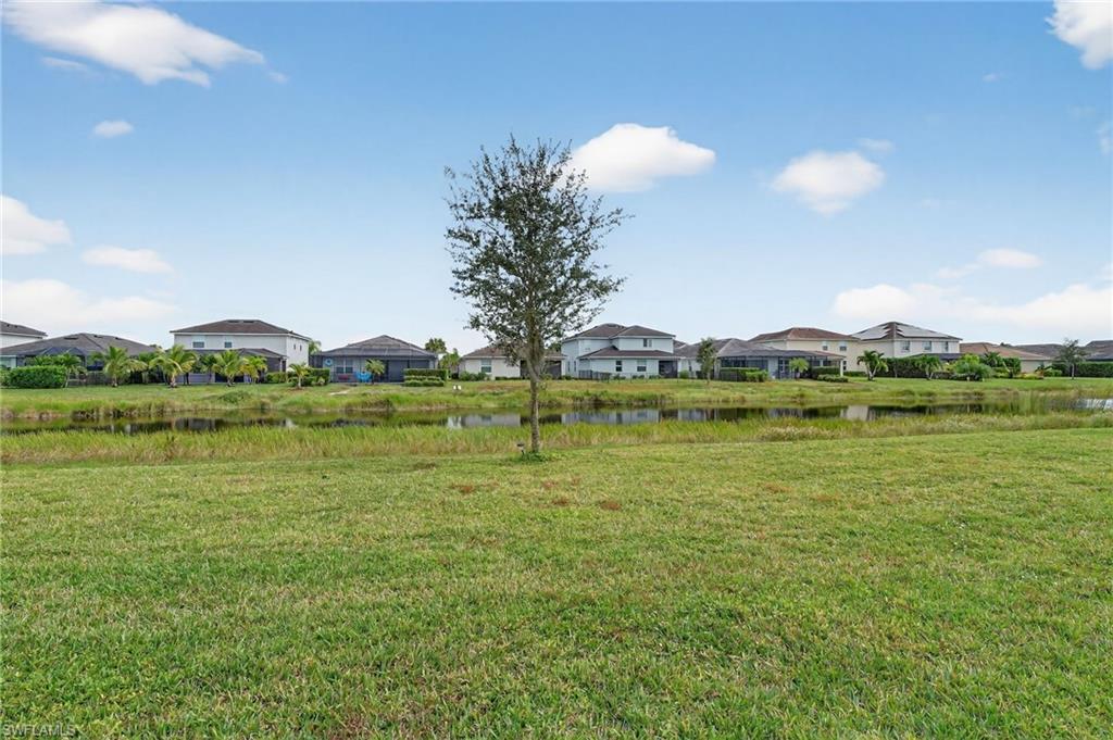 2126 Hamlin Street Naples, FL 34120 - Photo 29 of 38 a view of a lake with houses in the background