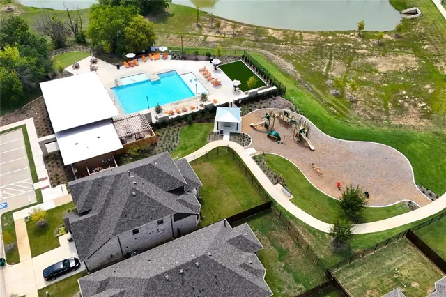an aerial view of a house with swimming pool garden and outdoor seating