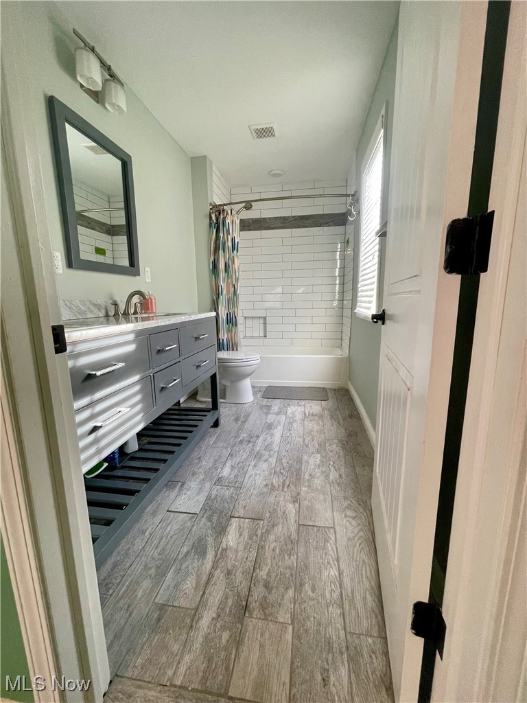 1544 Edgefield Road Lyndhurst, OH 44124 - Photo 32 of 36 Bathroom with vanity, shower / tub combo, and light wood-style flooring