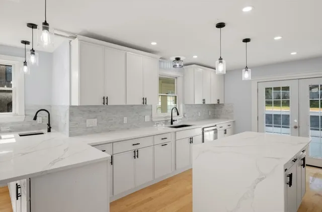 a kitchen with stainless steel appliances kitchen island a sink a stove and a refrigerator