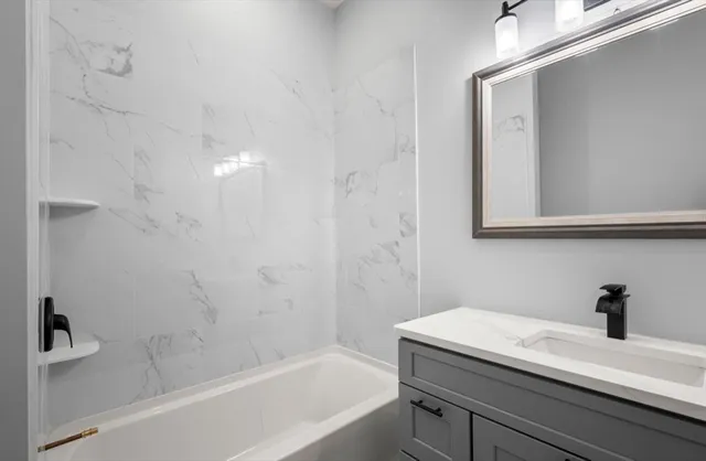 a bath room with a sink and a bath tub