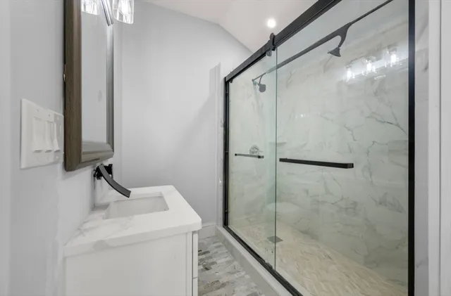 a bathroom with a shower and sink