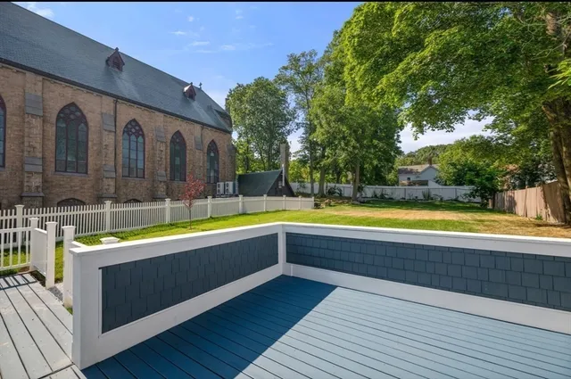 a view of swimming pool with seating area and trees in the background