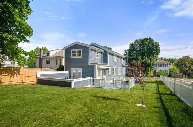 a front view of a house with a yard table and chairs