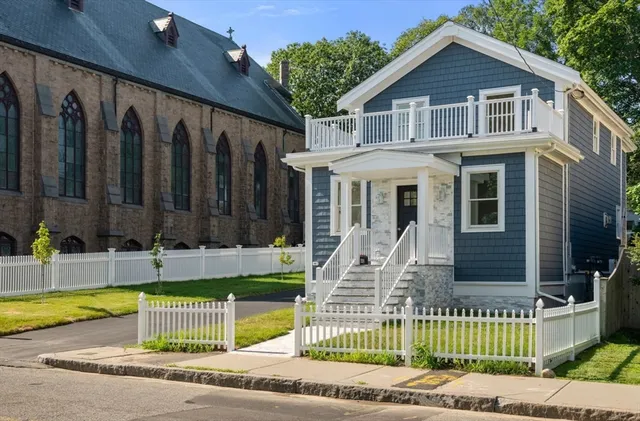 a front view of a house with a garden and plants
