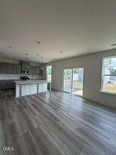 706 Old Station Angier, NC 27501 - Photo 4 of 19 a view of an empty room with a window and wooden floor