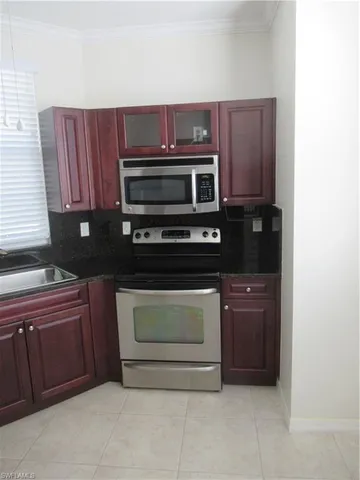 a kitchen with stainless steel appliances granite countertop a stove microwave and oven