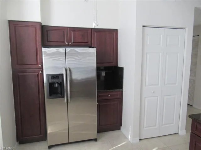 a kitchen with metallic refrigerator freezer and a dishwasher