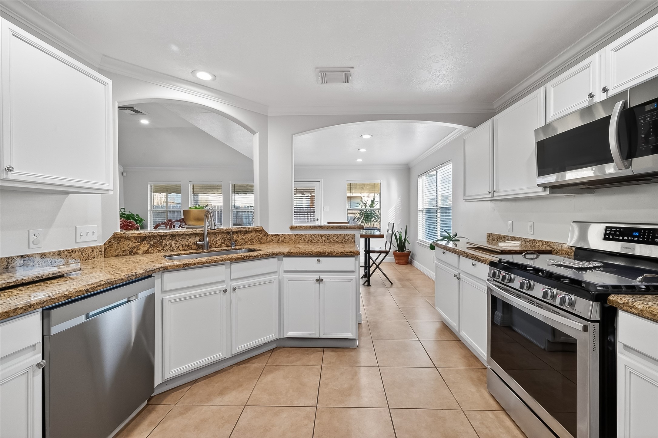 Spacious kitchen with granite countertops, stainless steel appliances, and abundant cabinetry.