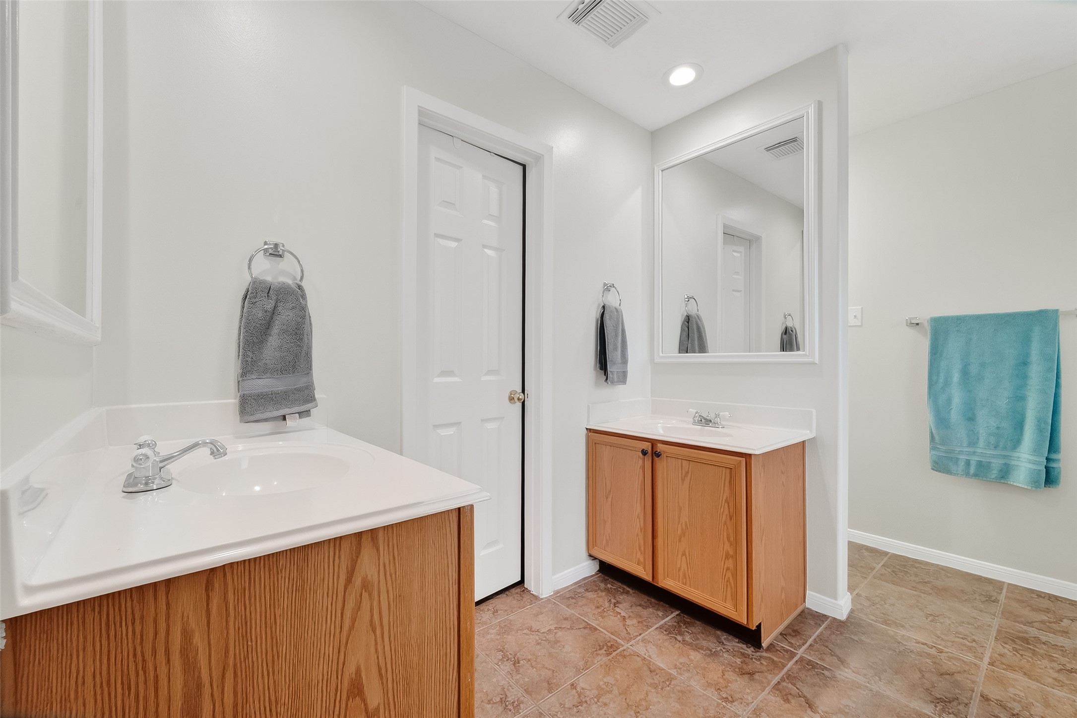 5902 Camron Point Circle Katy, TX 77449 - Photo 17 of 44 Primary bathroom with double sinks, large mirror, and bright neutral finishes.