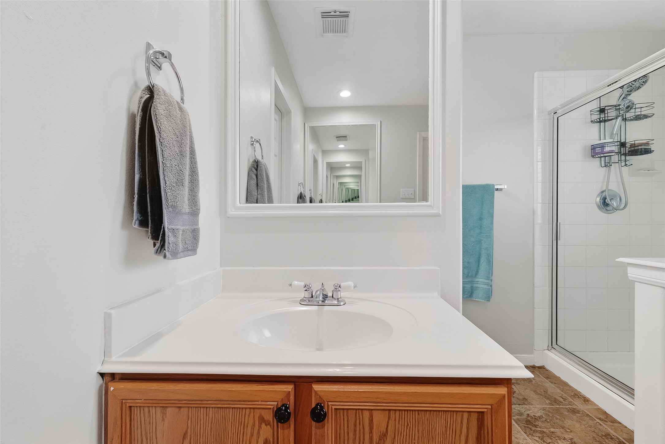 5902 Camron Point Circle Katy, TX 77449 - Photo 18 of 44 Bright Primary bathroom with vanity cabinet storage and functional layout.