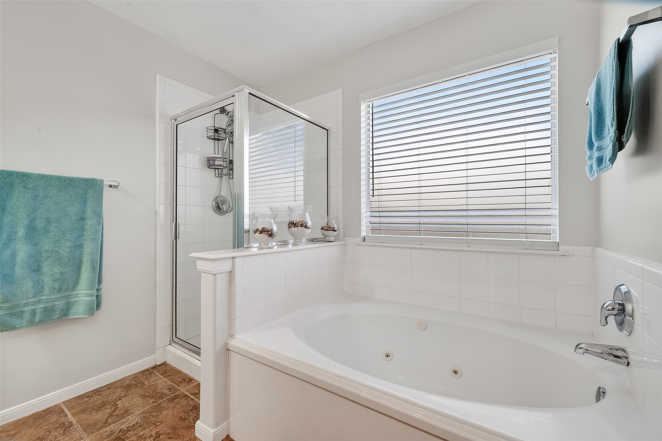 5902 Camron Point Circle Katy, TX 77449 - Photo 19 of 44 Spacious Primary bathroom featuring soaking tub, large window, and bright natural light.