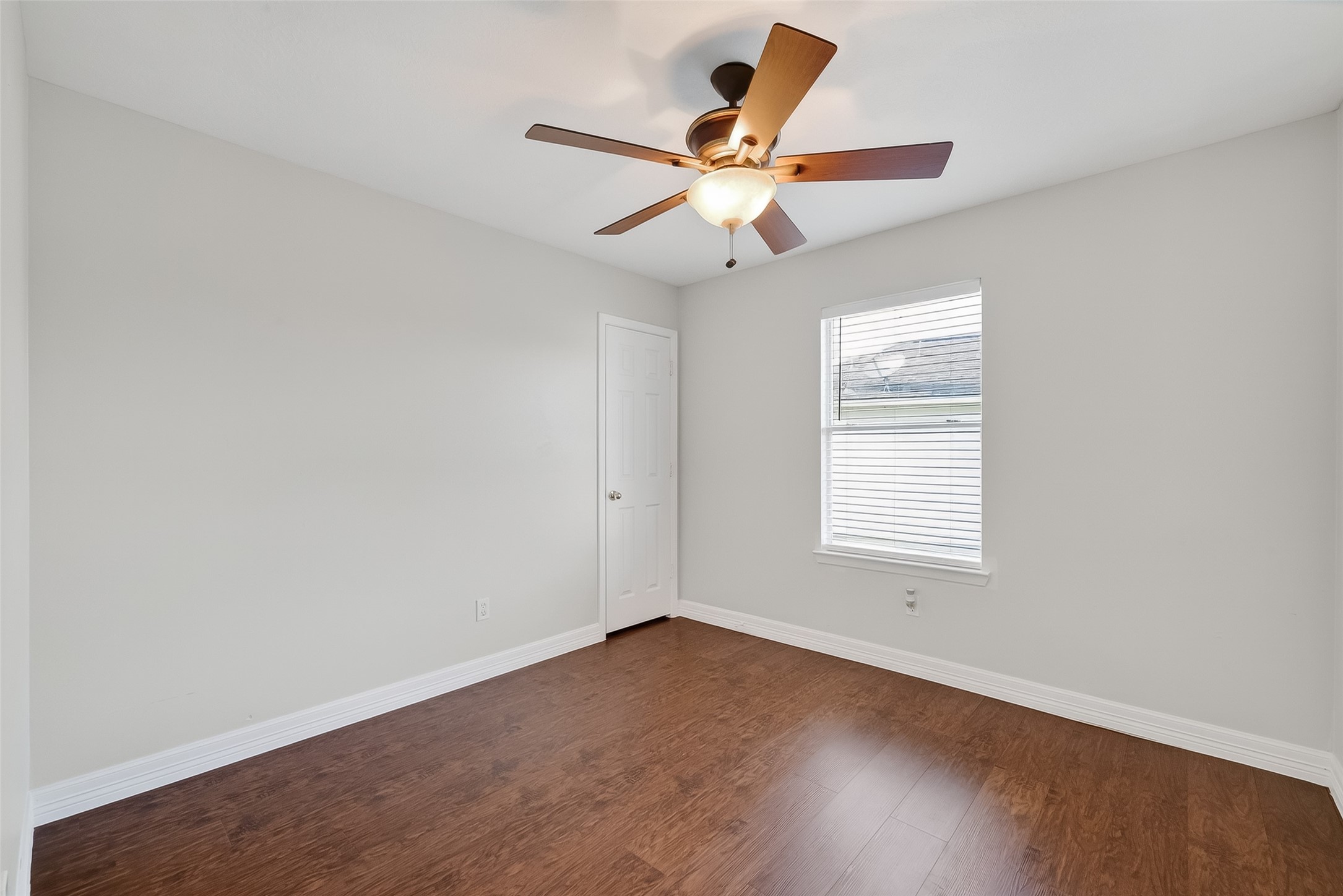 5902 Camron Point Circle Katy, TX 77449 - Photo 31 of 44 Bright fifth bedroom with hardwood flooring, ceiling fan, and versatile layout.
