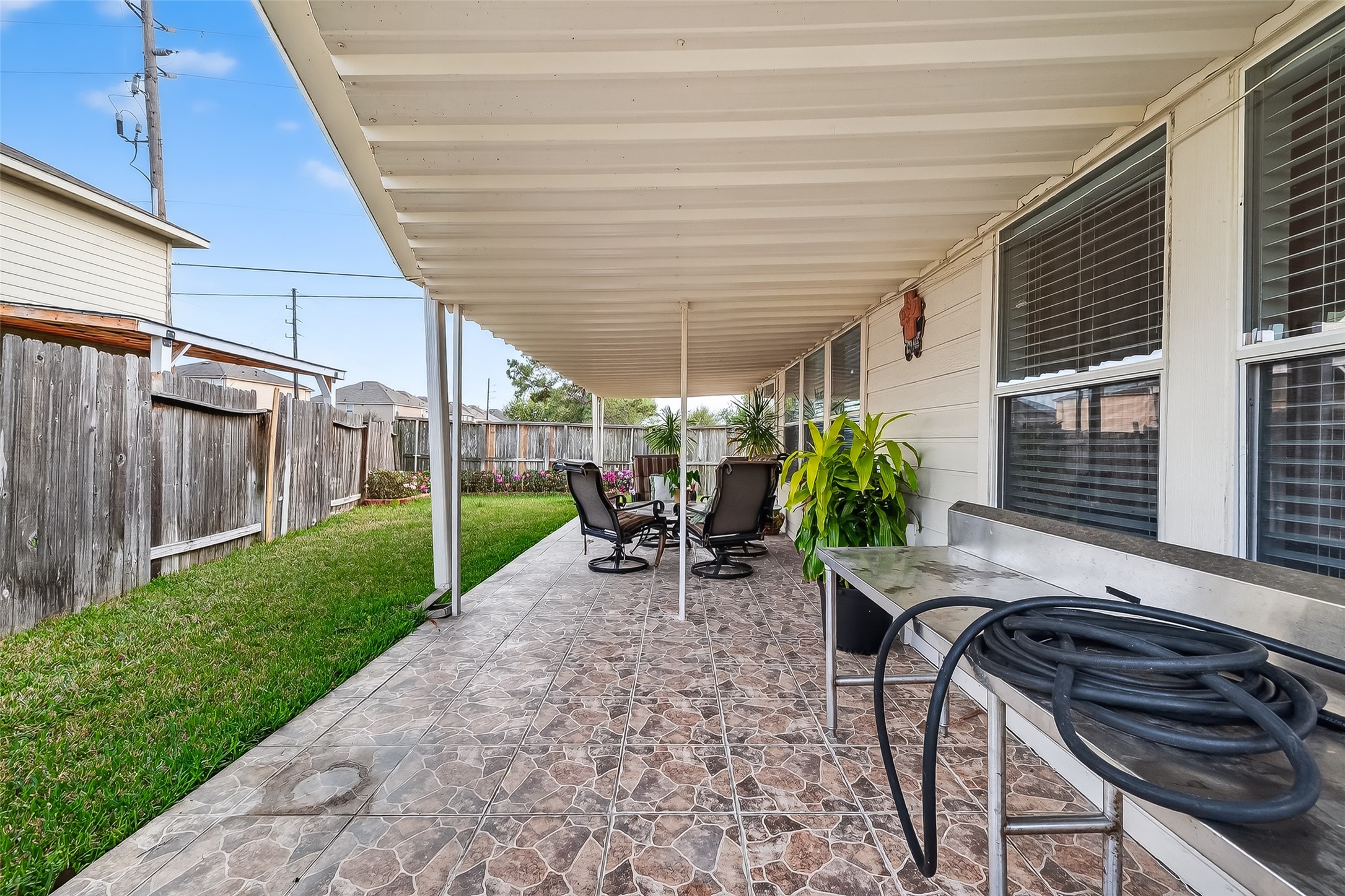 5902 Camron Point Circle Katy, TX 77449 - Photo 40 of 44 Extended covered patio with paved seating area and backyard views.