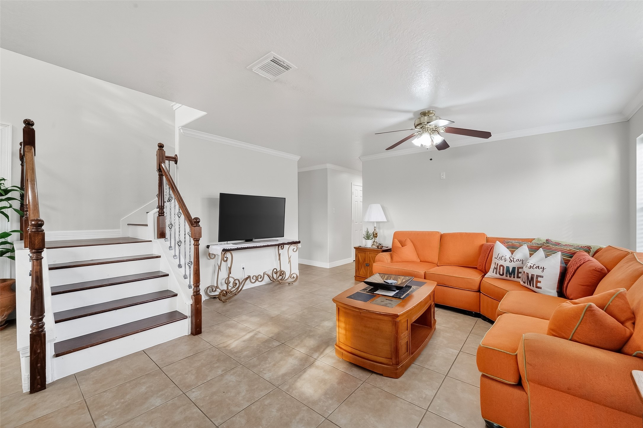 5902 Camron Point Circle Katy, TX 77449 - Photo 5 of 44 Comfortable living room with staircase access, neutral finishes, and open layout ideal for everyday living.