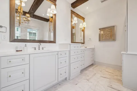 a bathroom with double sink and a mirror