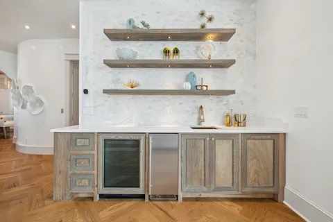 a kitchen with a sink a stove and cabinets