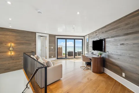 a living room with furniture tv and a flat screen tv