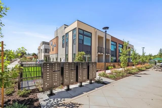 a view of a brick building next to a yard