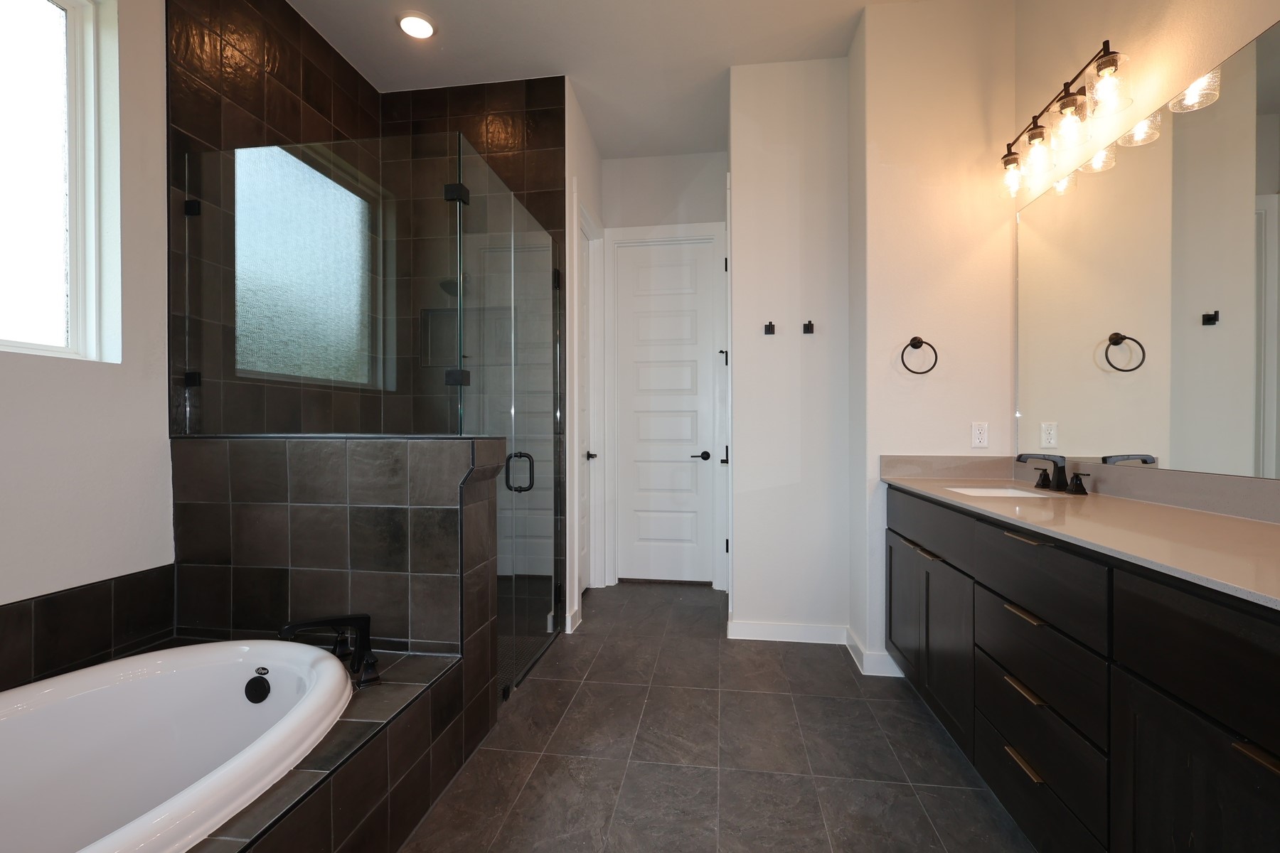 436 Leaning Rock Road Georgetown, TX 78628 - Photo 13 of 22 a bathroom with a tub sink and mirror