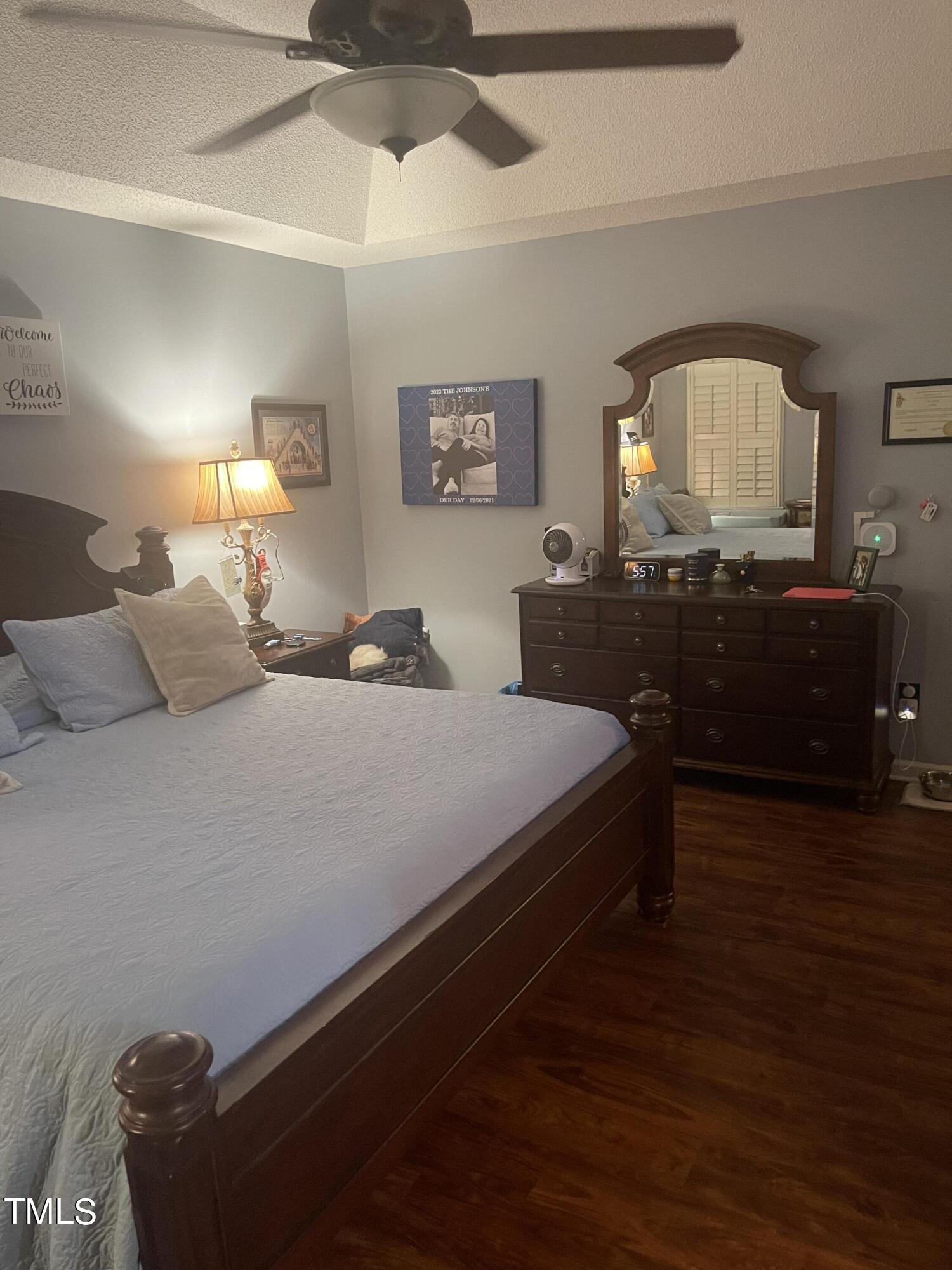 104 Chadbury Drive Dunn, NC 28334 - Photo 16 of 23 a bedroom with a bed and wooden floor