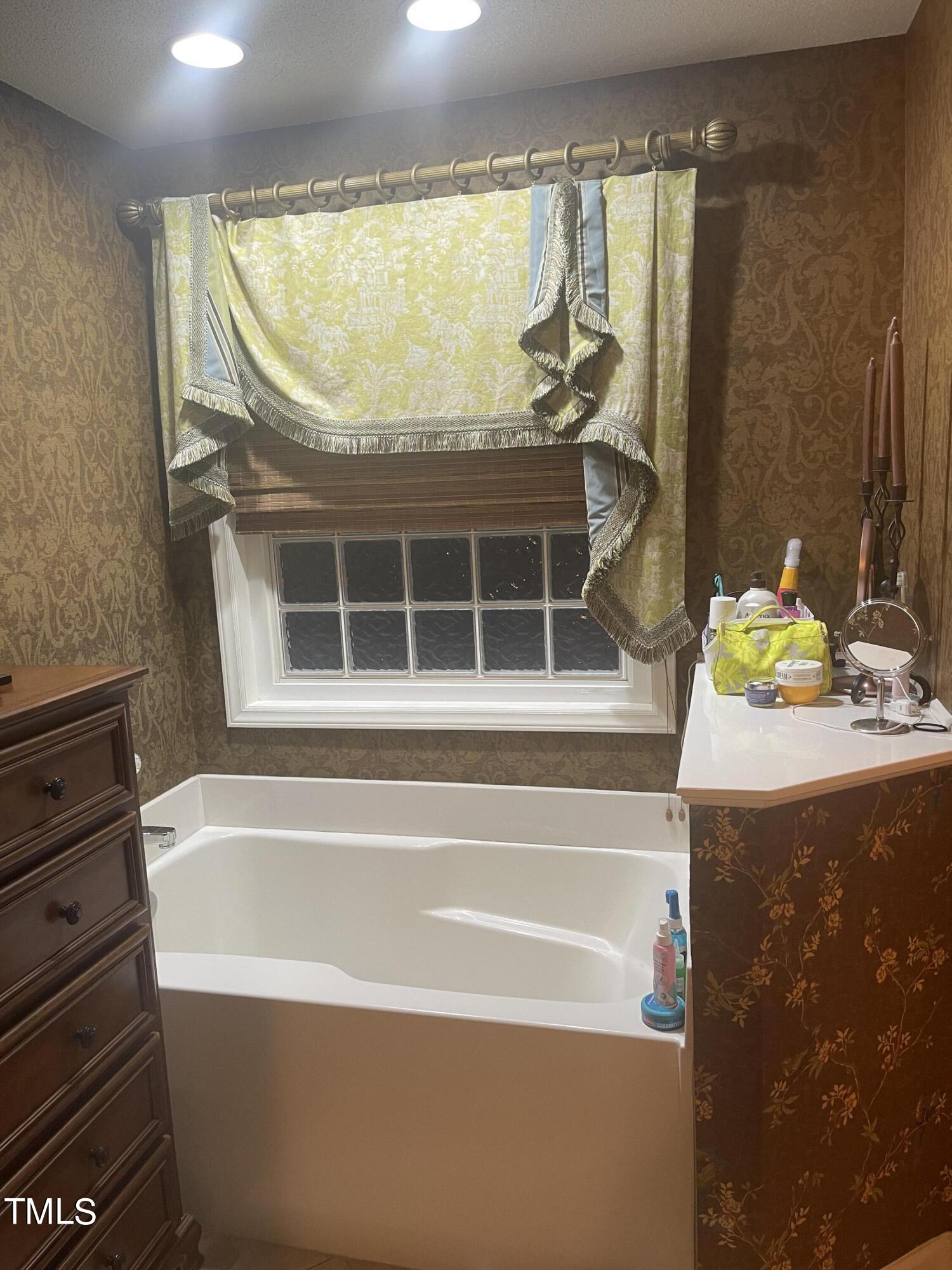 104 Chadbury Drive Dunn, NC 28334 - Photo 18 of 23 a bathroom with a tub and a sink