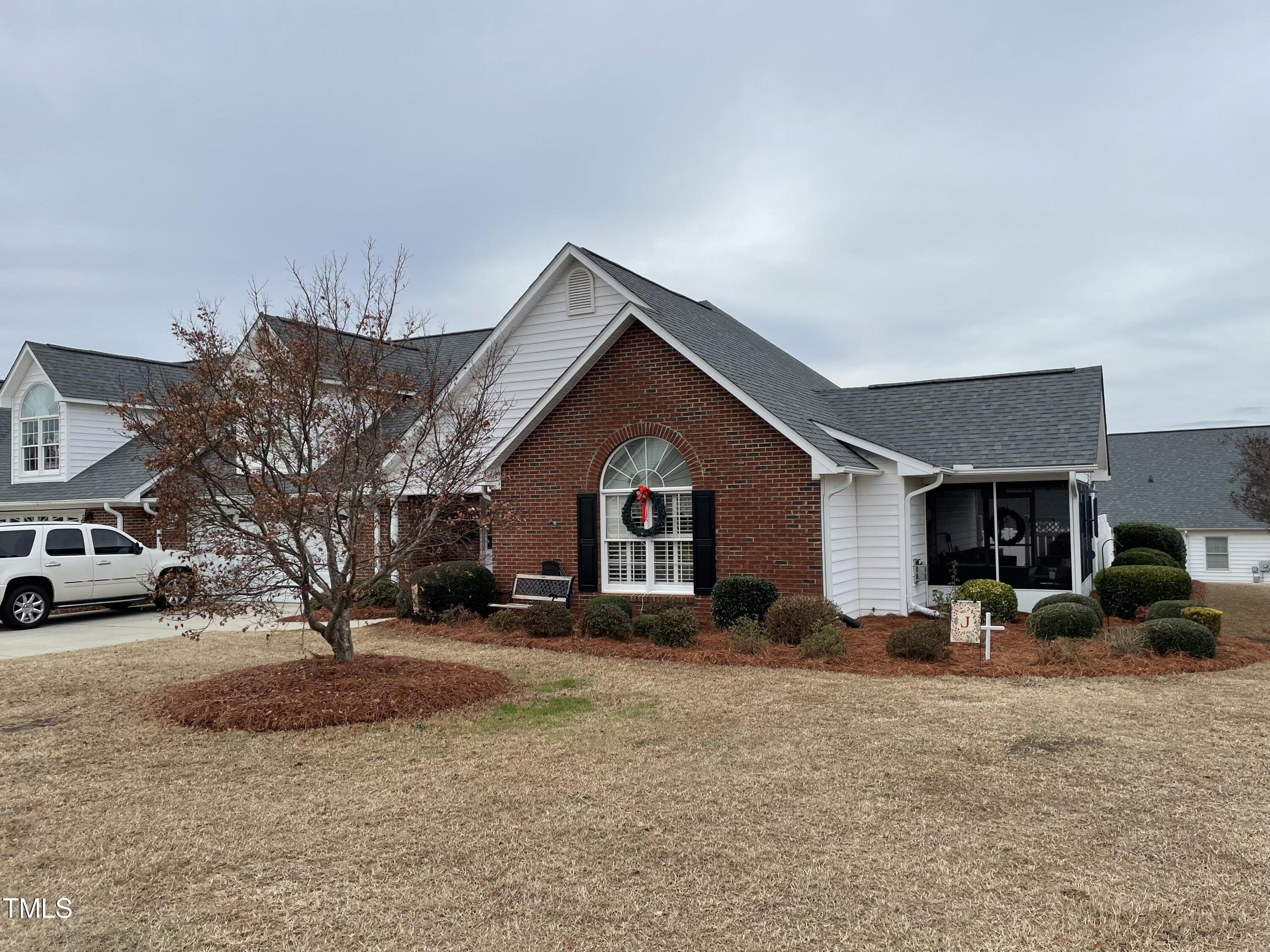 104 Chadbury Drive Dunn, NC 28334 - Photo 2 of 23 a view of a house with a yard covered in snow