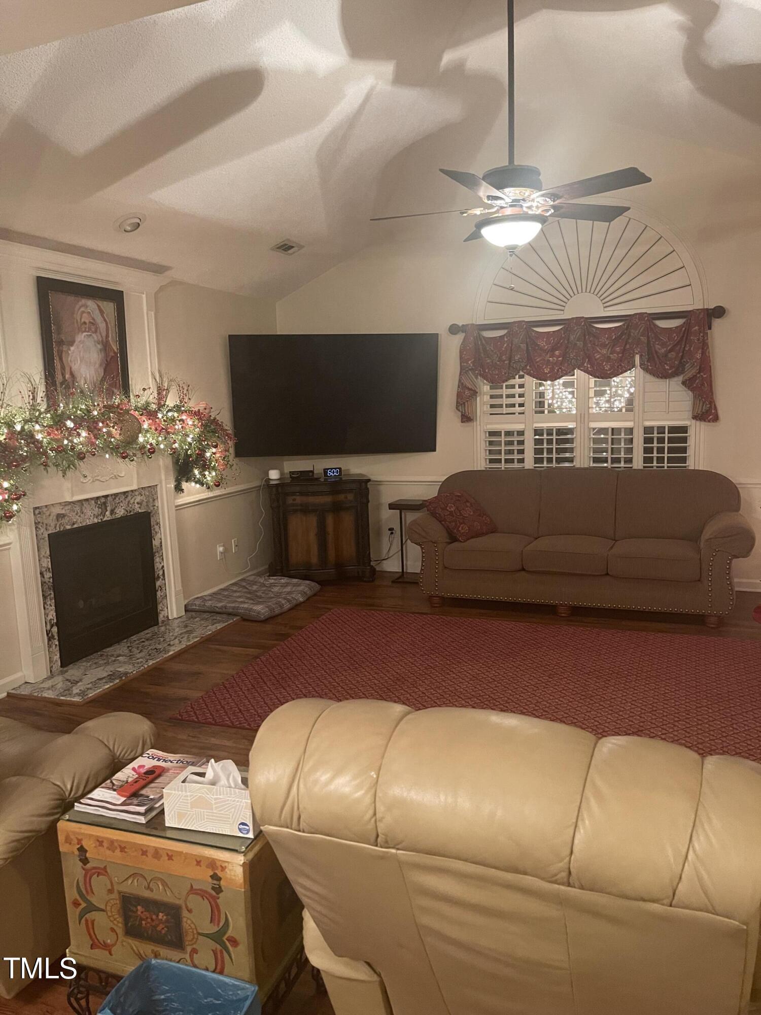 104 Chadbury Drive Dunn, NC 28334 - Photo 7 of 23 a living room with furniture a flat screen tv and a fireplace