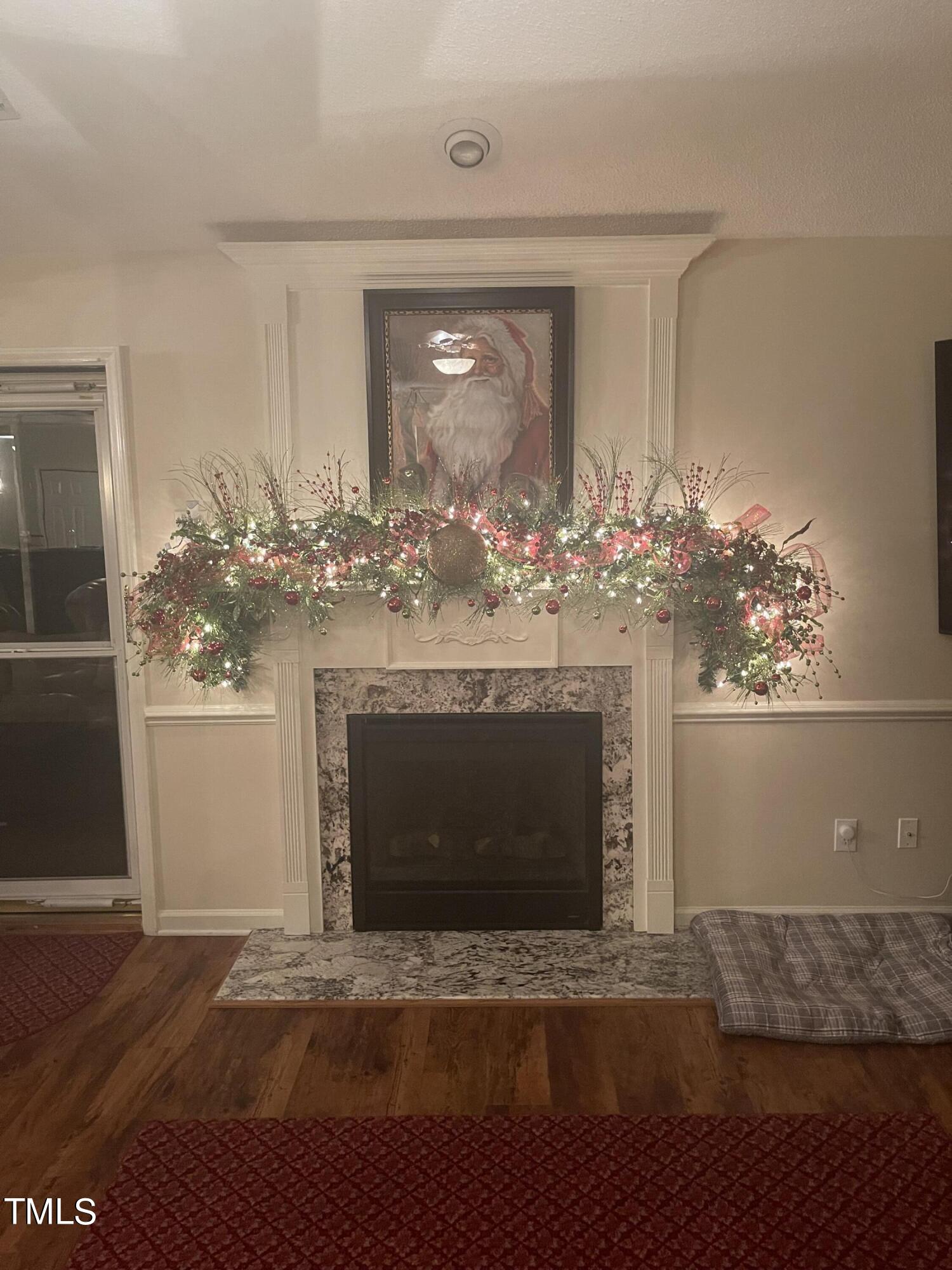 104 Chadbury Drive Dunn, NC 28334 - Photo 10 of 23 a living room with a fireplace and chandelier